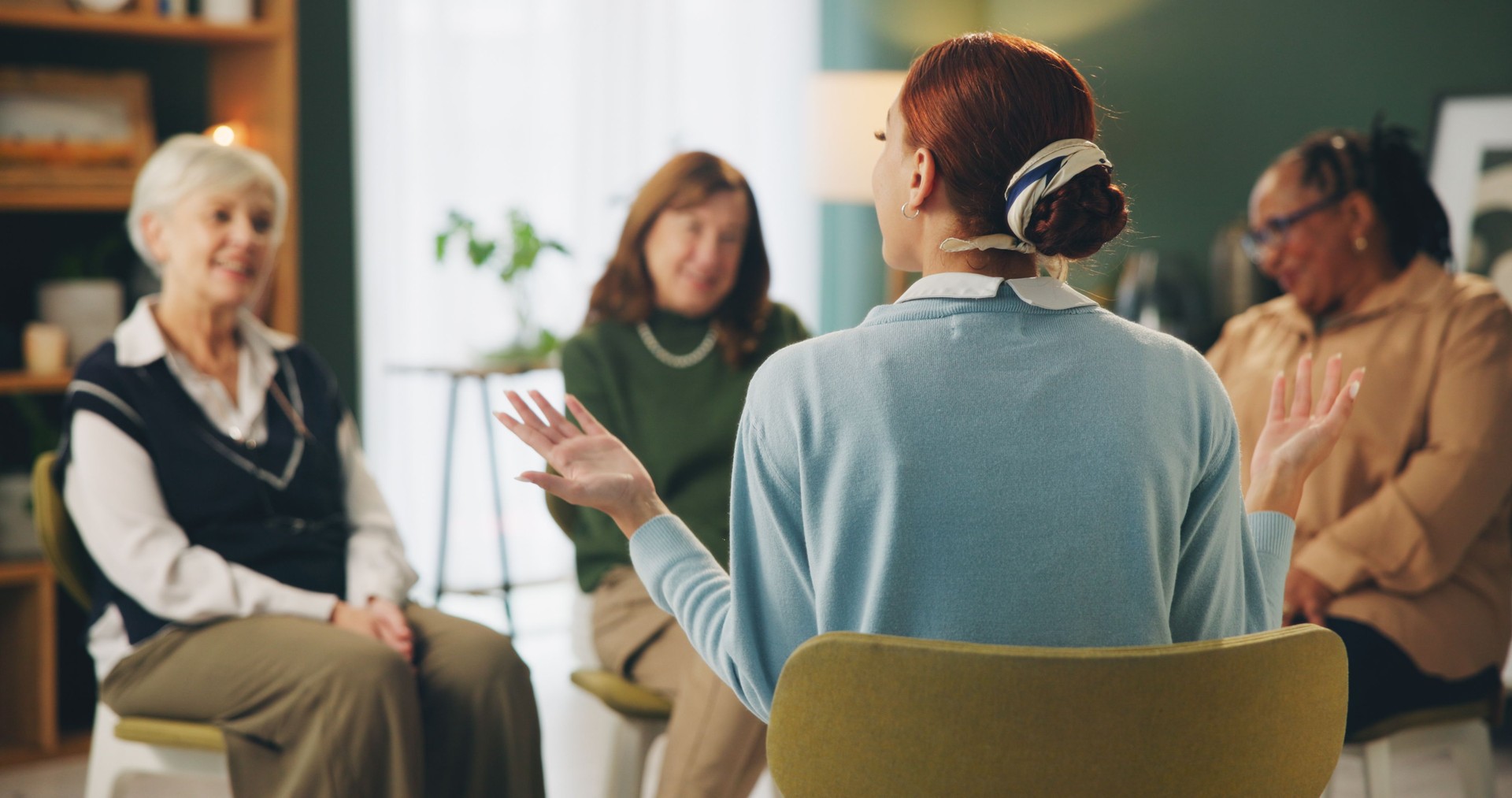 Group therapy, counseling and women with therapist for support, psychology and discussion of mental health. Circle of people listening to psychologist talking and CBT therapy for helping with aging